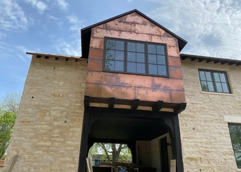 Copper metal panel facade on a stone building for Skylight Installation in Nocatee